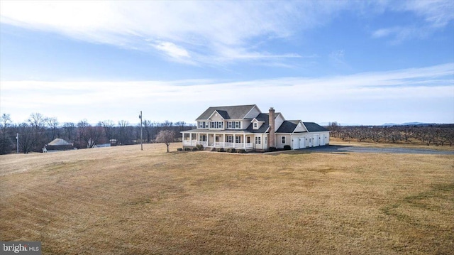 view of front of house with a front yard and covered porch