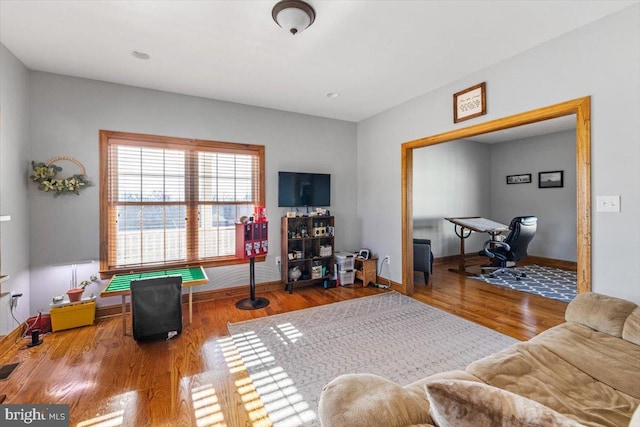 interior space with baseboards and wood finished floors