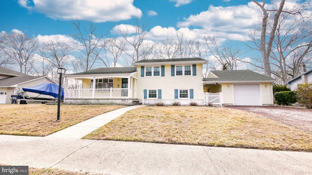 split level home featuring driveway, a gate, a porch, a front yard, and an attached garage