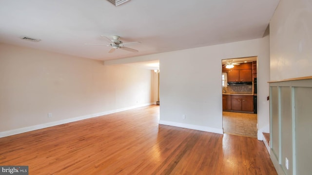 unfurnished room featuring visible vents, baseboards, light wood-style floors, and ceiling fan