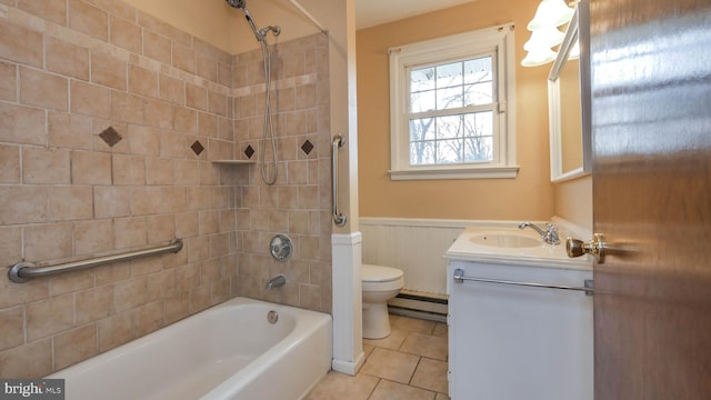 bathroom featuring vanity, a wainscoted wall, a baseboard radiator, tile patterned floors, and toilet