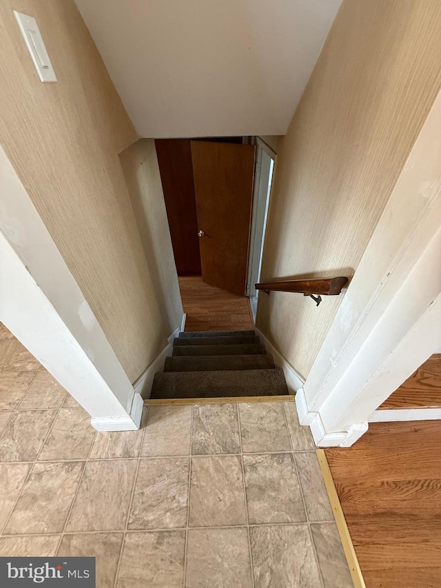 stairway with tile patterned floors