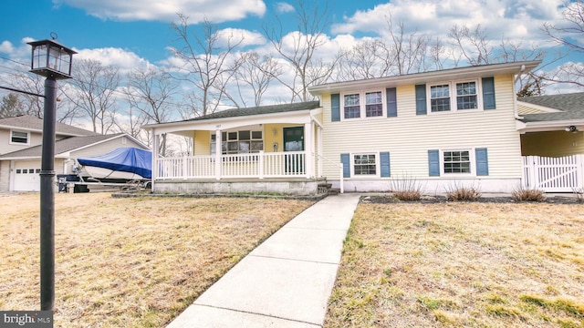 split level home featuring covered porch and a front lawn