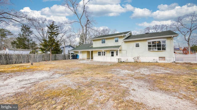 rear view of house featuring a patio area and fence private yard