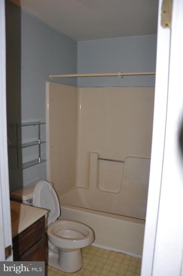 bathroom with toilet, shower / washtub combination, vanity, and tile patterned floors