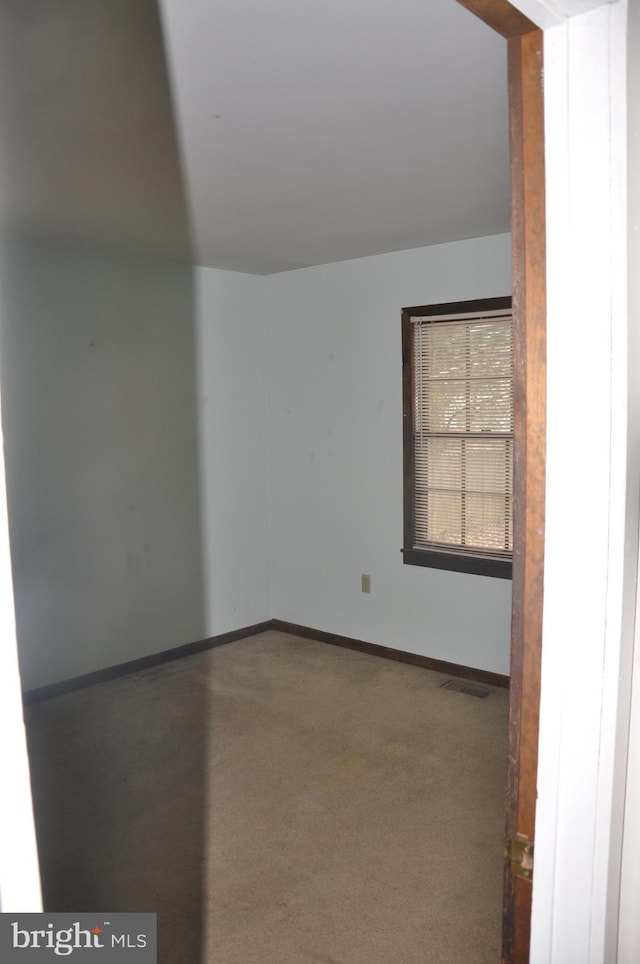 spare room featuring visible vents and baseboards