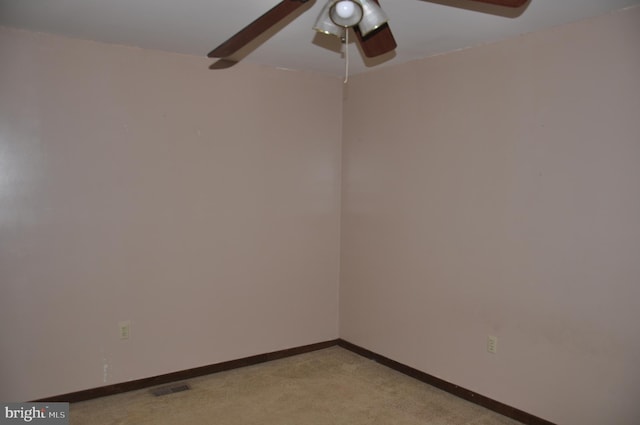 empty room with light carpet, baseboards, visible vents, and ceiling fan