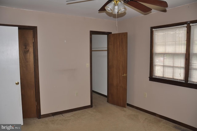 unfurnished bedroom featuring visible vents, baseboards, ceiling fan, and light colored carpet