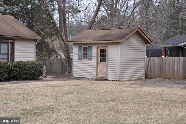 view of outbuilding with an outbuilding and fence