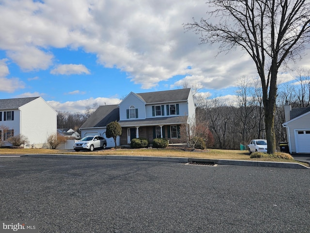 traditional-style house featuring a garage and brick siding