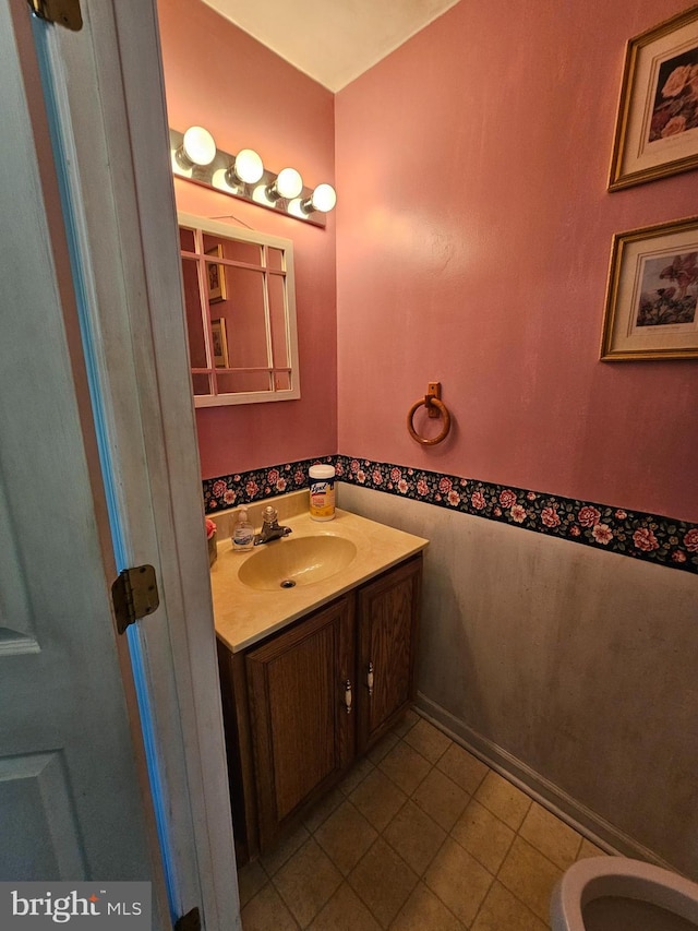 bathroom featuring tile patterned flooring, vanity, and toilet