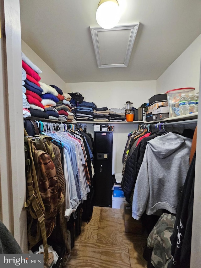 walk in closet featuring attic access