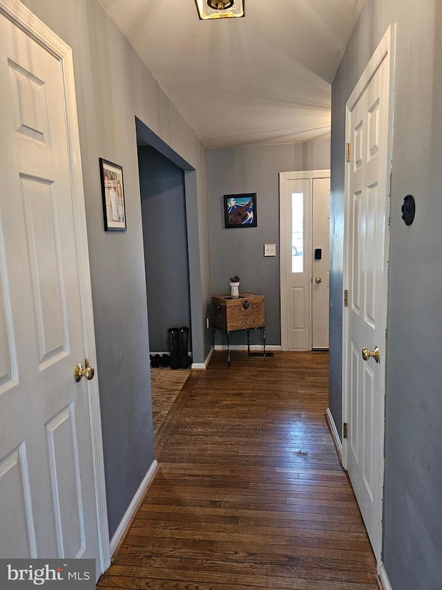 interior space featuring dark wood-style floors and baseboards