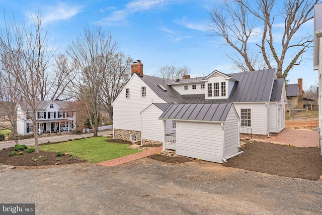 15570 Second St, Waterford, VA 20197 - back of house with a standing seam roof, metal roof, a chimney, and a lawn