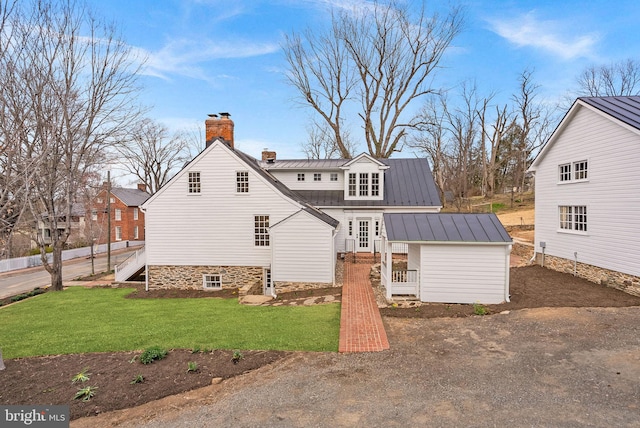 15570 Second St, Waterford, VA 20197 - back of house with a chimney, a standing seam roof, metal roof, and a yard