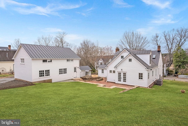 15570 Second St, Waterford, VA 20197 - rear view of property with a chimney, central air condition unit, french doors, a yard, and metal roof