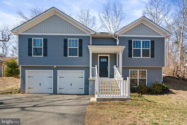 split foyer home with driveway and a garage