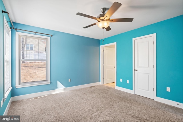 unfurnished bedroom featuring ceiling fan, carpet flooring, and baseboards