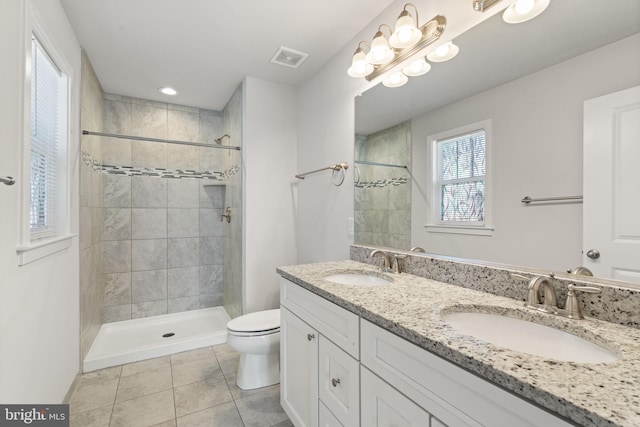 bathroom featuring toilet, tile patterned flooring, a sink, and visible vents