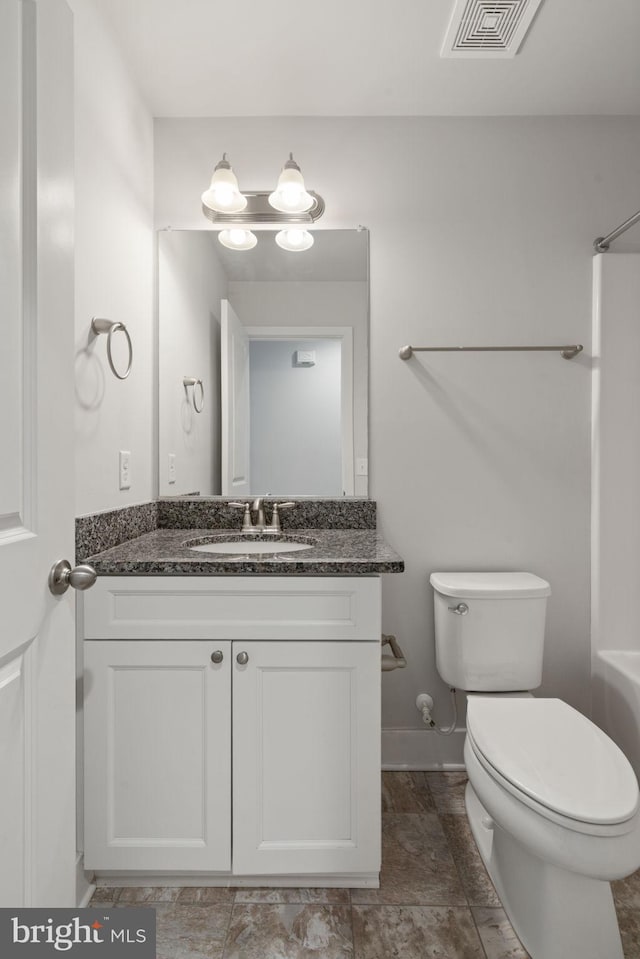 bathroom with baseboards, visible vents, vanity, and toilet