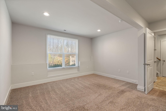 empty room featuring recessed lighting, visible vents, baseboards, and light colored carpet