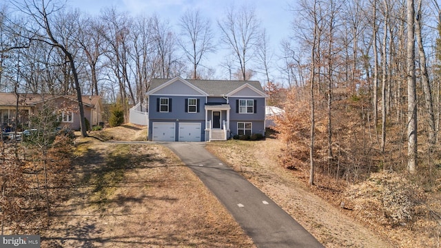 split foyer home featuring a garage and driveway