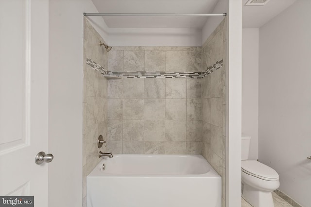 bathroom featuring shower / bath combination and toilet