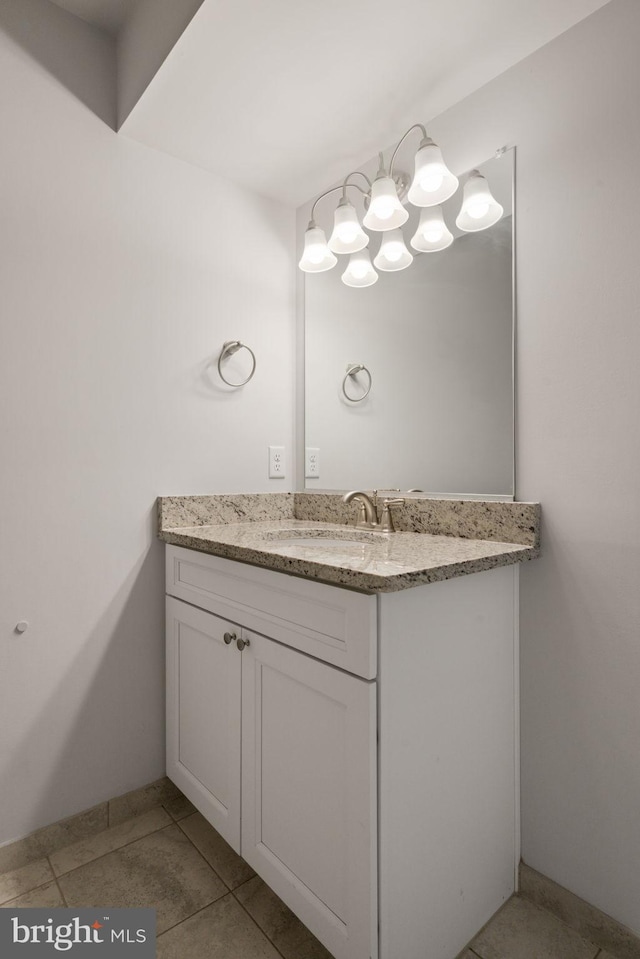 bathroom with tile patterned flooring, vanity, and baseboards