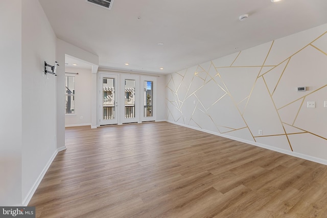 unfurnished living room featuring baseboards, recessed lighting, and light wood-style floors