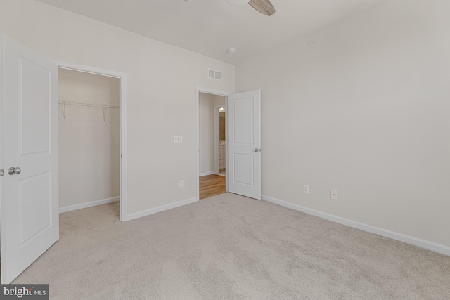 unfurnished bedroom featuring carpet, a closet, visible vents, and baseboards