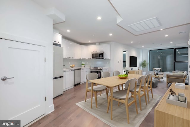 dining area with recessed lighting, visible vents, and light wood-style floors