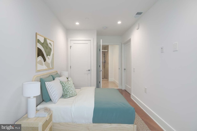 bedroom with visible vents, wood finished floors, recessed lighting, and baseboards