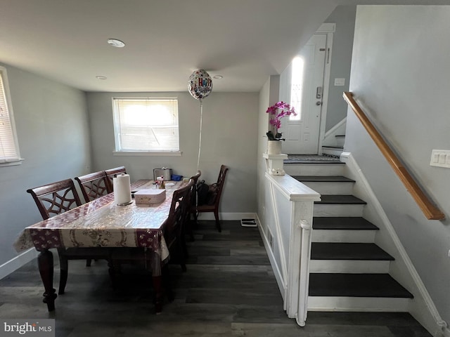 dining space with stairway, wood finished floors, and baseboards