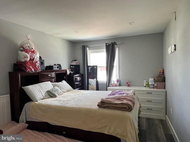 bedroom featuring dark wood finished floors and baseboards