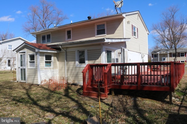 back of house with a lawn