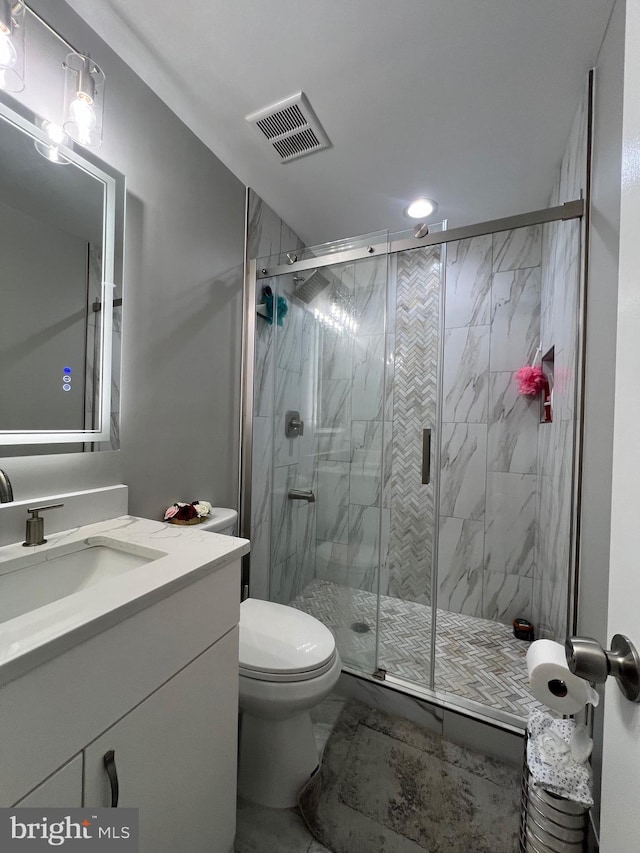 full bathroom with visible vents, toilet, marble finish floor, vanity, and a shower stall