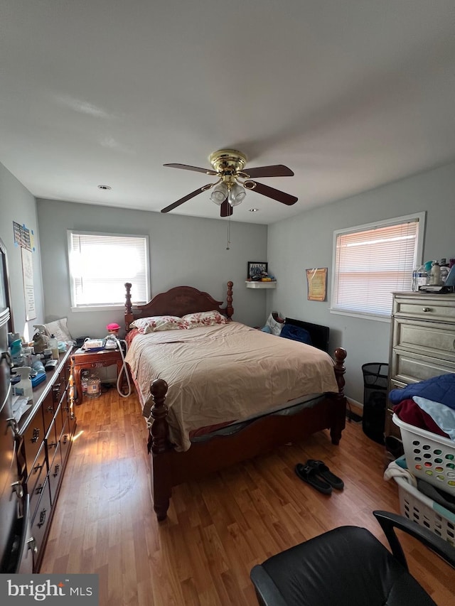 bedroom with light wood-style flooring and ceiling fan