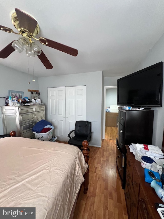 bedroom with a closet, a ceiling fan, and wood finished floors