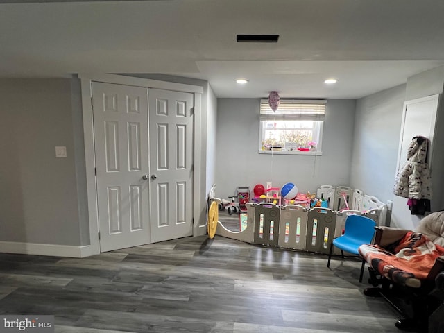 recreation room with recessed lighting, wood finished floors, and baseboards