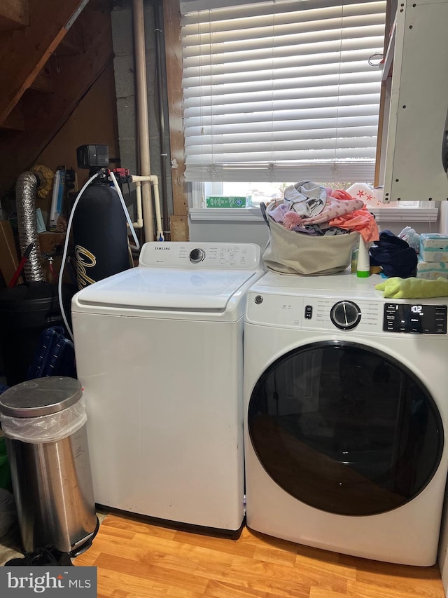 laundry area featuring light wood-style floors, laundry area, and independent washer and dryer