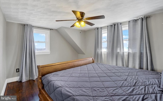 bedroom featuring ceiling fan, baseboards, and wood finished floors