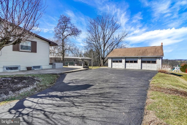 view of side of property featuring a garage and an outdoor structure