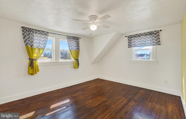 interior space with hardwood / wood-style flooring, a ceiling fan, baseboards, and a wealth of natural light