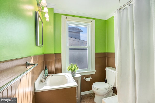 full bathroom with tile patterned flooring, toilet, a wainscoted wall, vanity, and crown molding