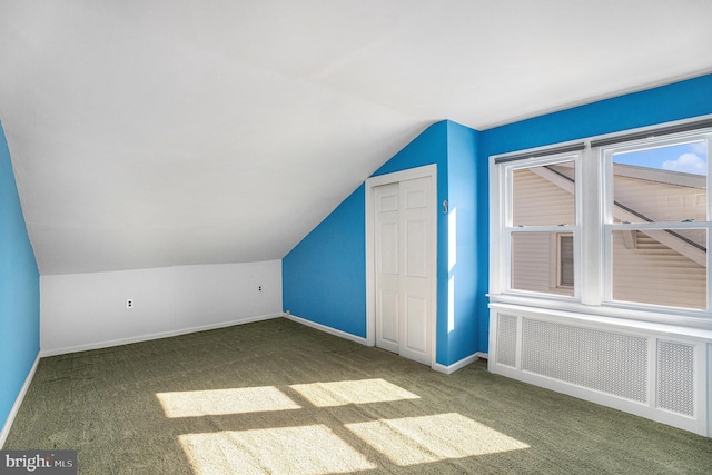 bonus room with lofted ceiling, radiator, carpet flooring, and baseboards