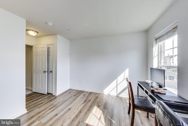 office featuring baseboards and wood finished floors