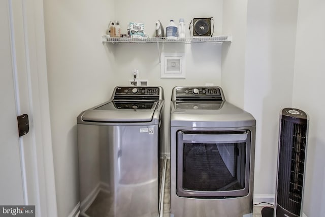 washroom with washing machine and dryer and laundry area