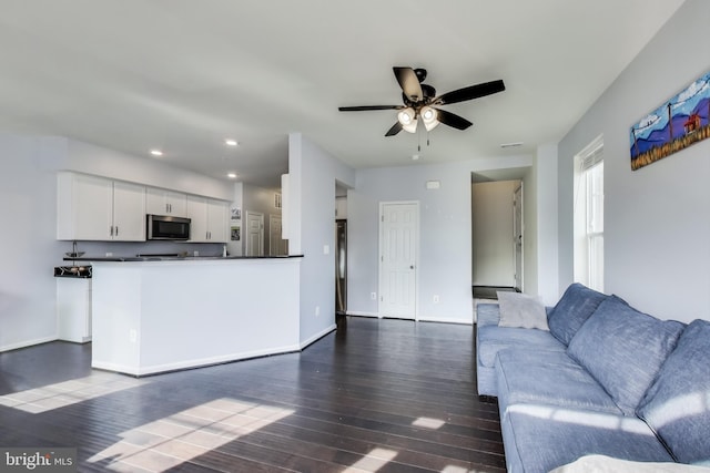 unfurnished living room with visible vents, recessed lighting, baseboards, ceiling fan, and dark wood-style flooring