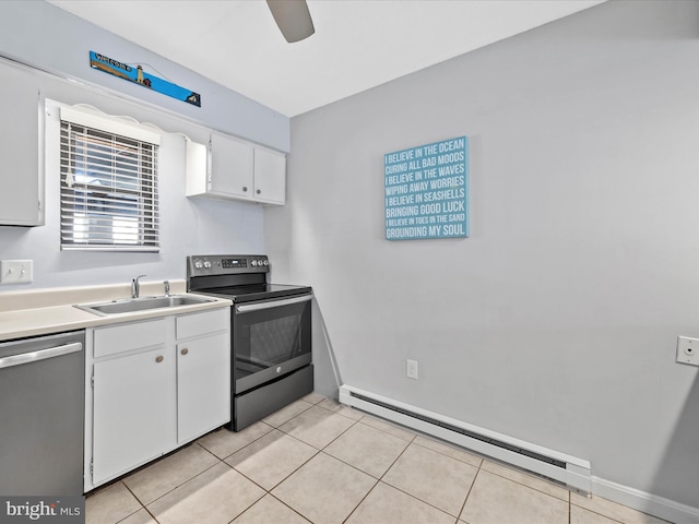 kitchen featuring a baseboard radiator, light tile patterned floors, white cabinets, stainless steel appliances, and a sink