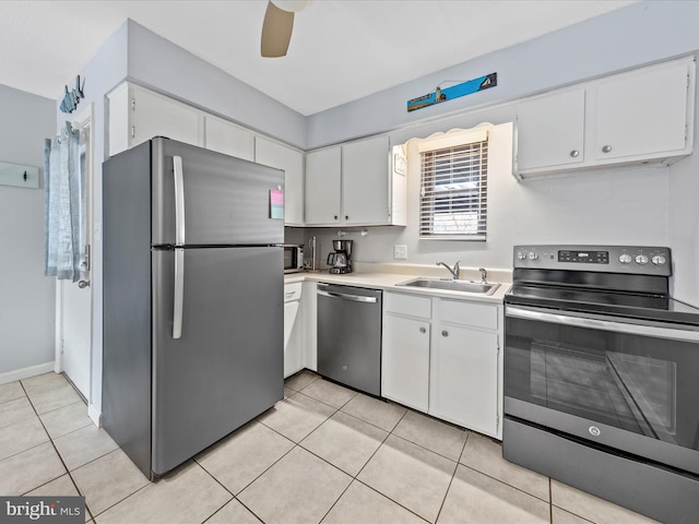 kitchen with appliances with stainless steel finishes, white cabinetry, and a sink